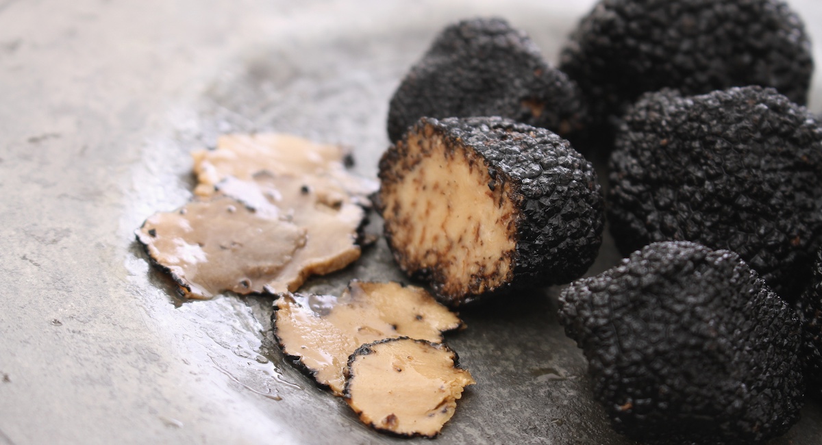 Sliced black truffle on plate