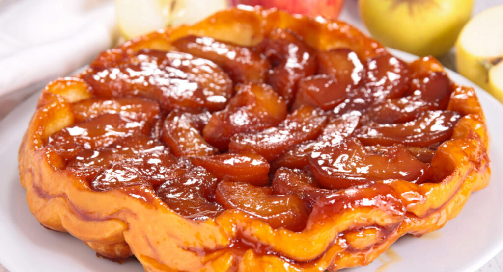 A tarte tatin covered with icing sugar.