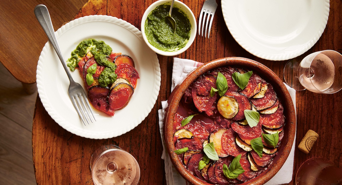 Ratatouille and side of pistou on wooden table