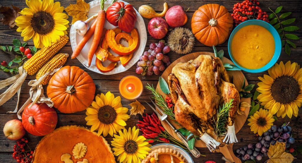 Thanksgiving dinner spread, with turkey, squash, and seasonal vegetables