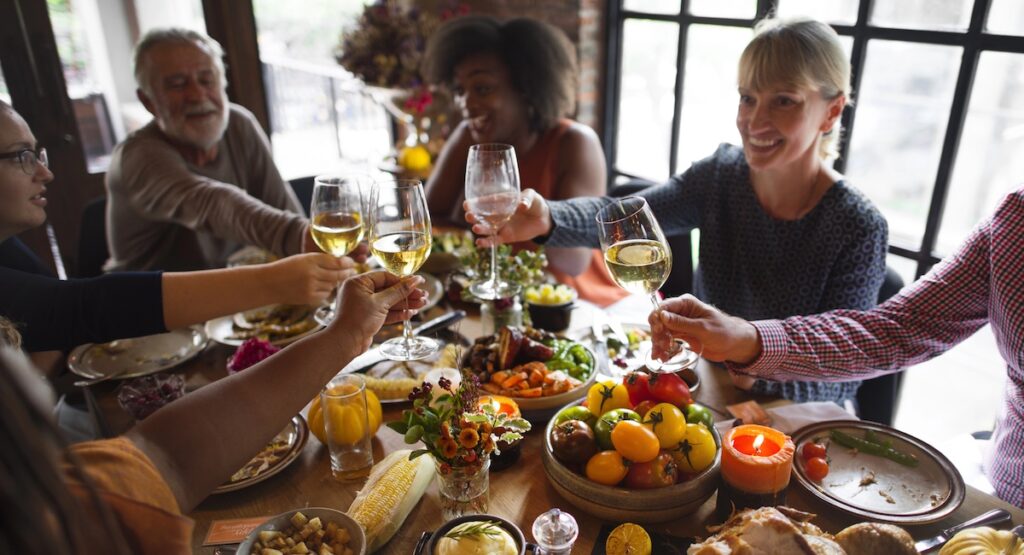 People share a toast over a Thanksgiving dinner