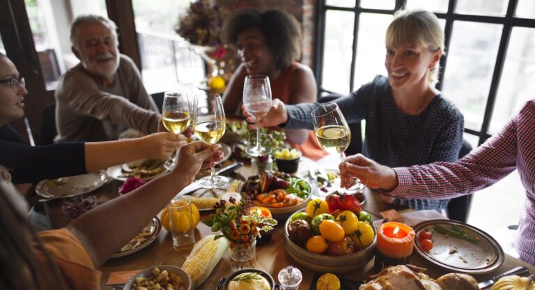 People share a toast over a Thanksgiving dinner