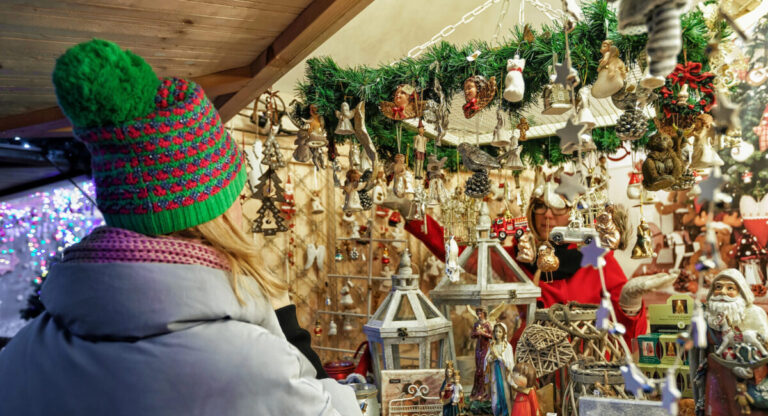 STRASBOURG, FRANCE - NOV 28, 2015: Woman looking at christmas decorations in Strasbours Christmas Market.