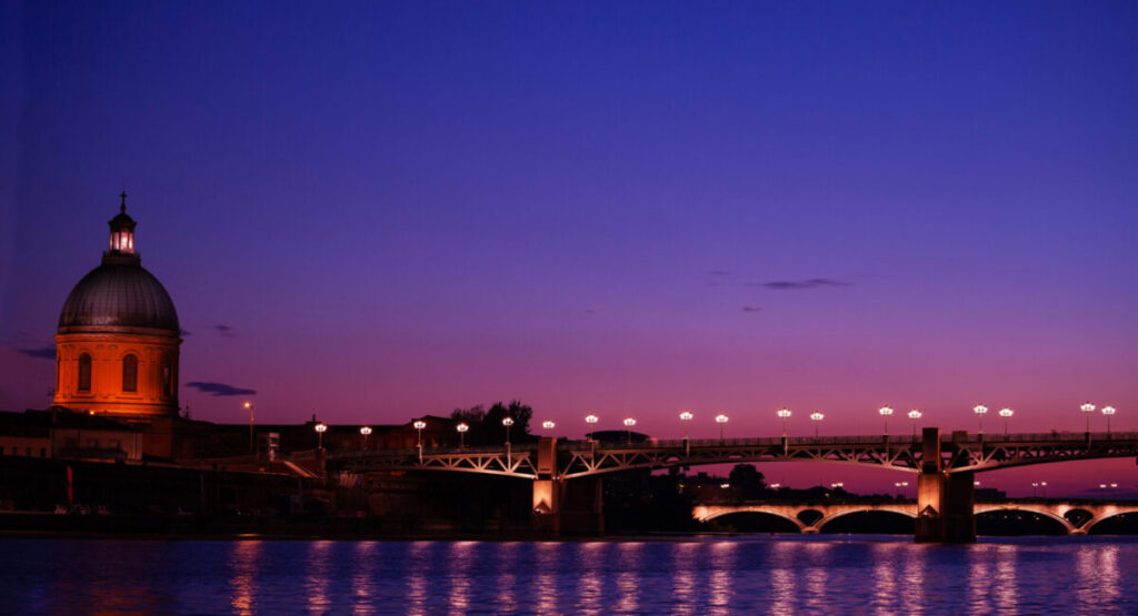 Night view of the Garonne river with illuminated Saint Pierre.