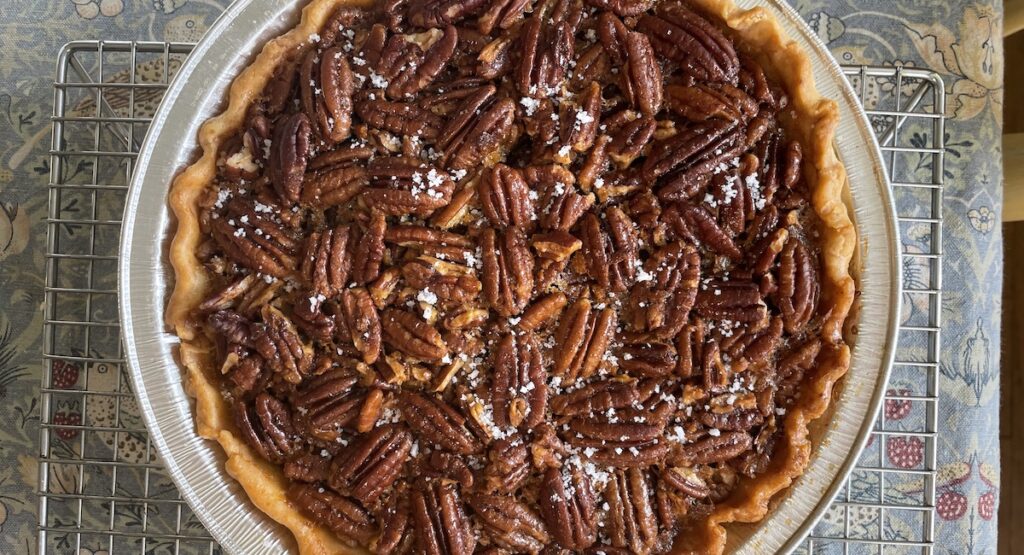 Pecan pie on cooling rack, viewed from above