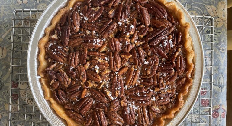 Pecan pie on cooling rack, viewed from above