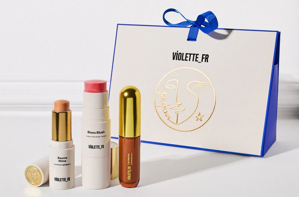 Assorted beauty products with bag in background