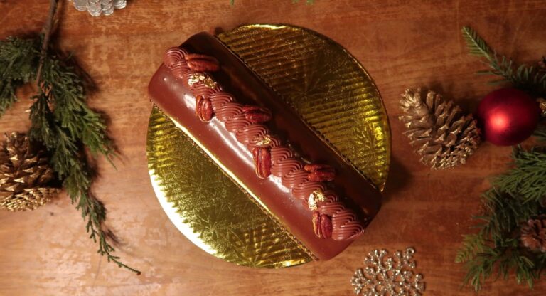 Buche de Noel on table with festive decorations