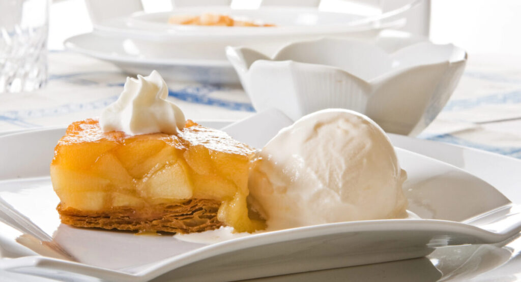 Tarte tatin with ice cream and whipped cream.