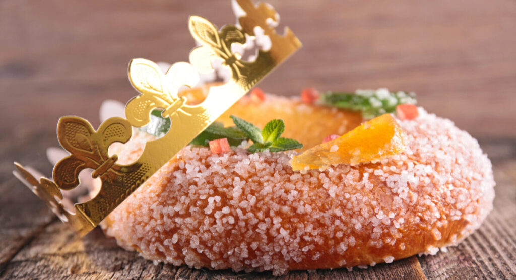A fruit brioche with a golden paper crown. 