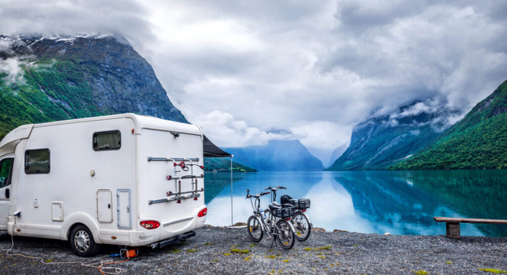 Holiday trip in a van in front of a lake.