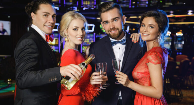 Group of happy people during celebration drinking sparkling wine.