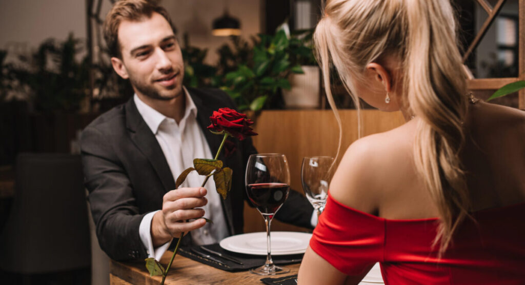 A couple is having a romantic dinner at restaurant.