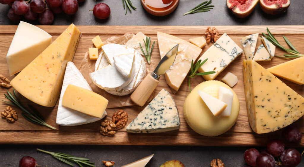 Flat lay composition with different types of cheeses.