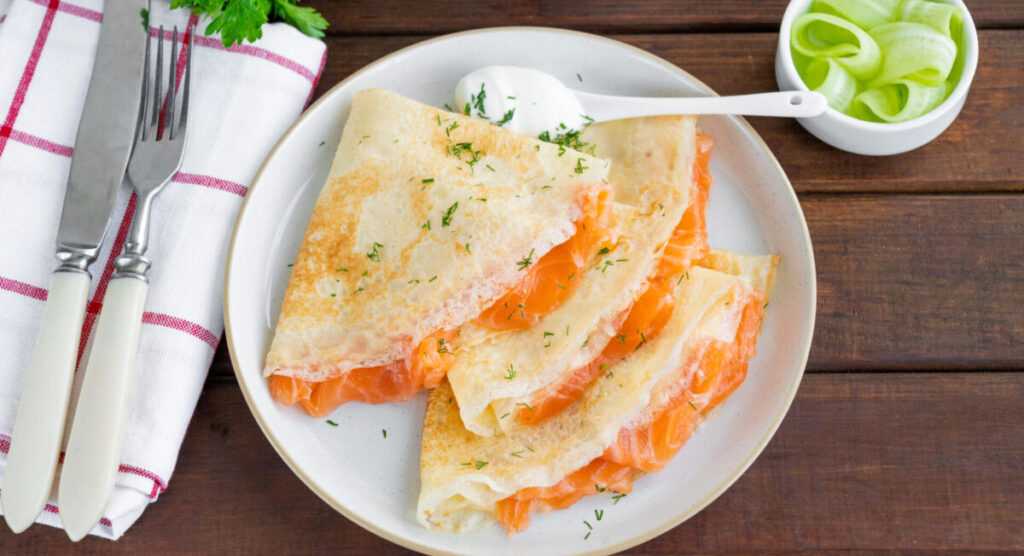 Thin crepes with smoked salmon and cream cheese.