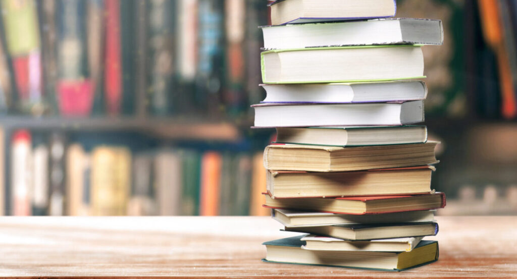 A stack of books on the shelf.