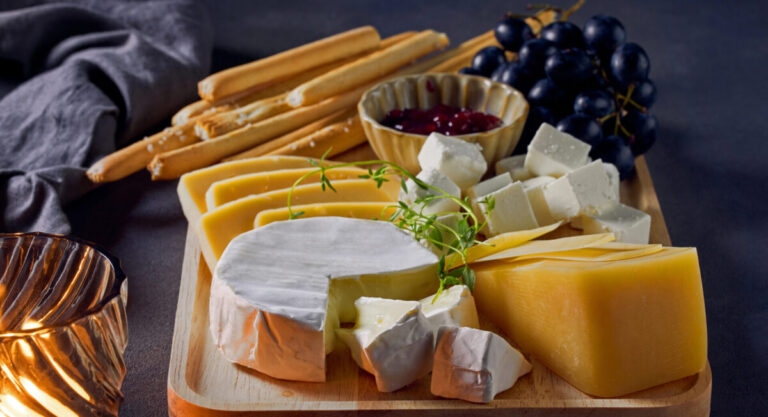 Cheese board with bread sticks.