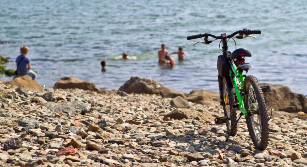 Cyclists are swimming in the sea.