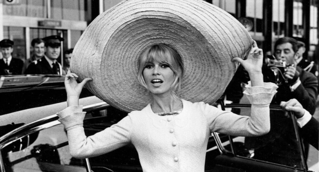 Brigitte Bardot wearing a huge hat.