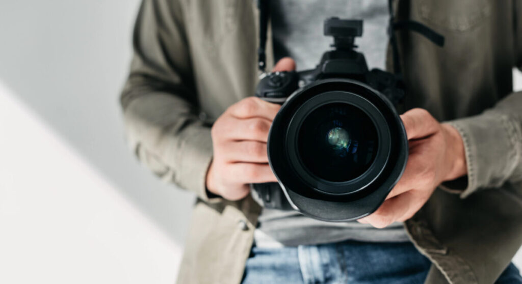 Photographer with digital photo camera.