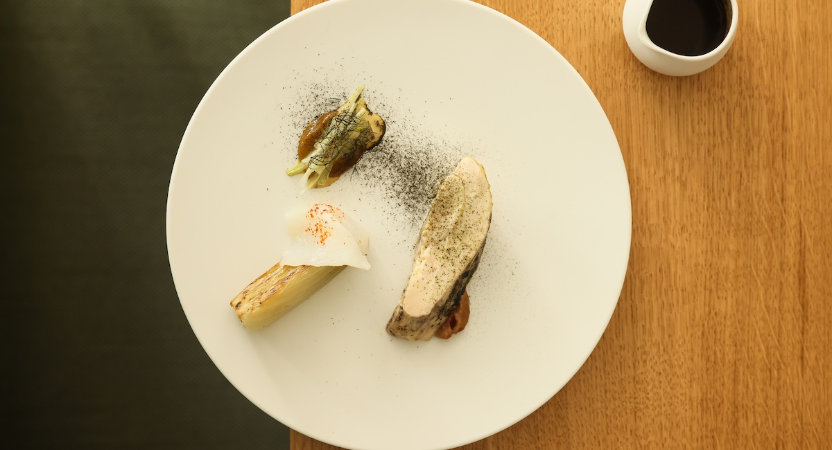 Artfully plated fine dining meal on white plate.