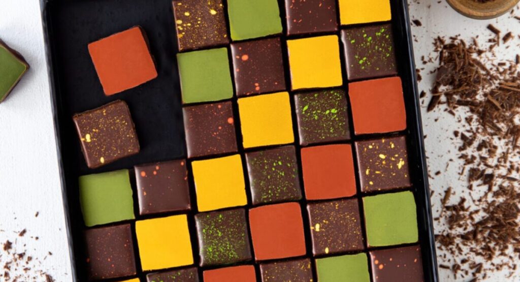 Box of assorted chocolates in various colors.