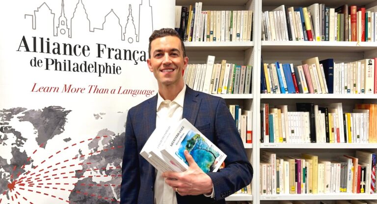 AF Philadelphie Director, Philippe Poirier, standing in front of bookcase.