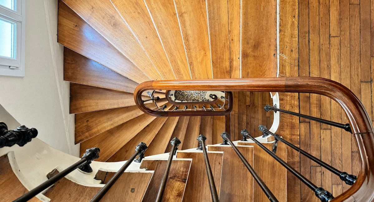 Looking down from above view of a narrow staircase in an old apartment building in Paris, France.