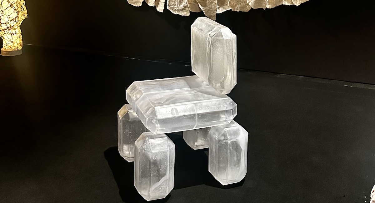 Chair designed to look like crystal against black backdrop.