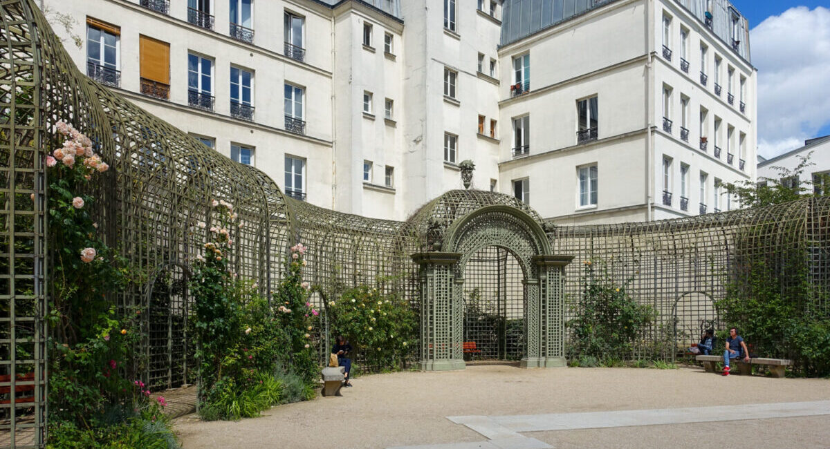 paris rose garden surrounded by buildings