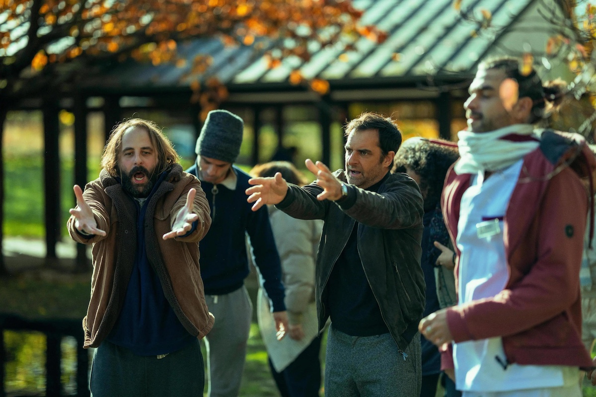 People arguing and waving their arms on film set.