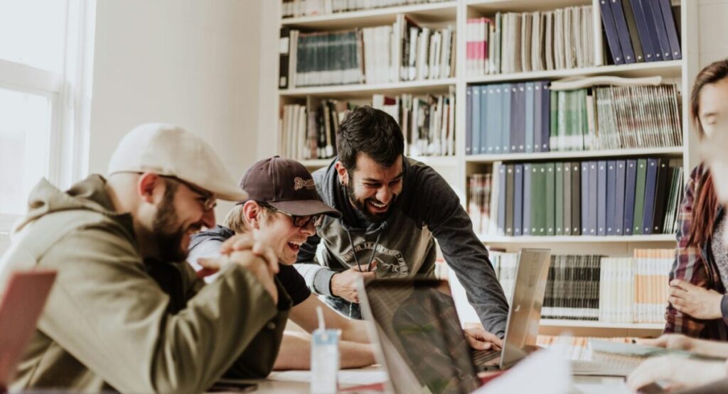 Students are chatting in front of computers.