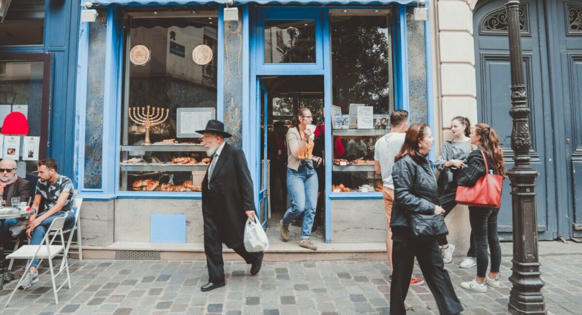 people outside of a bakery in paris