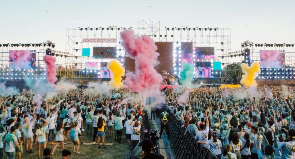 A crowd in front of a music festival stage.