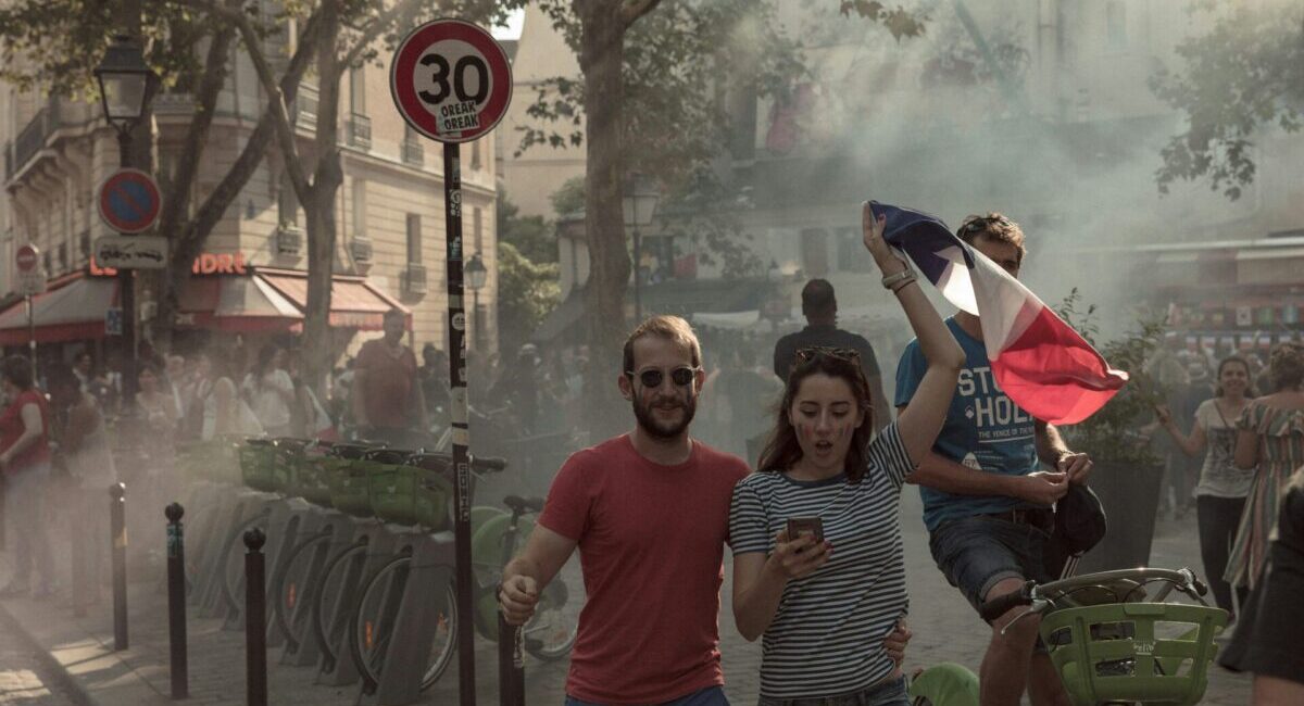 a man and woman on street with french flag