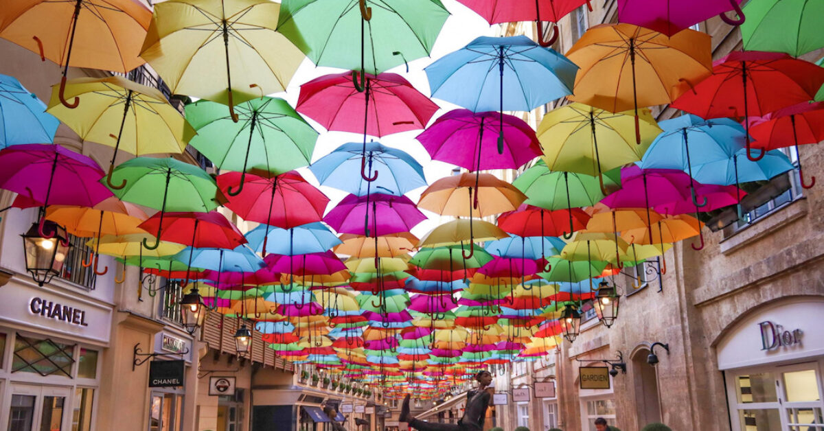 A colorful umbrella hanging from a building