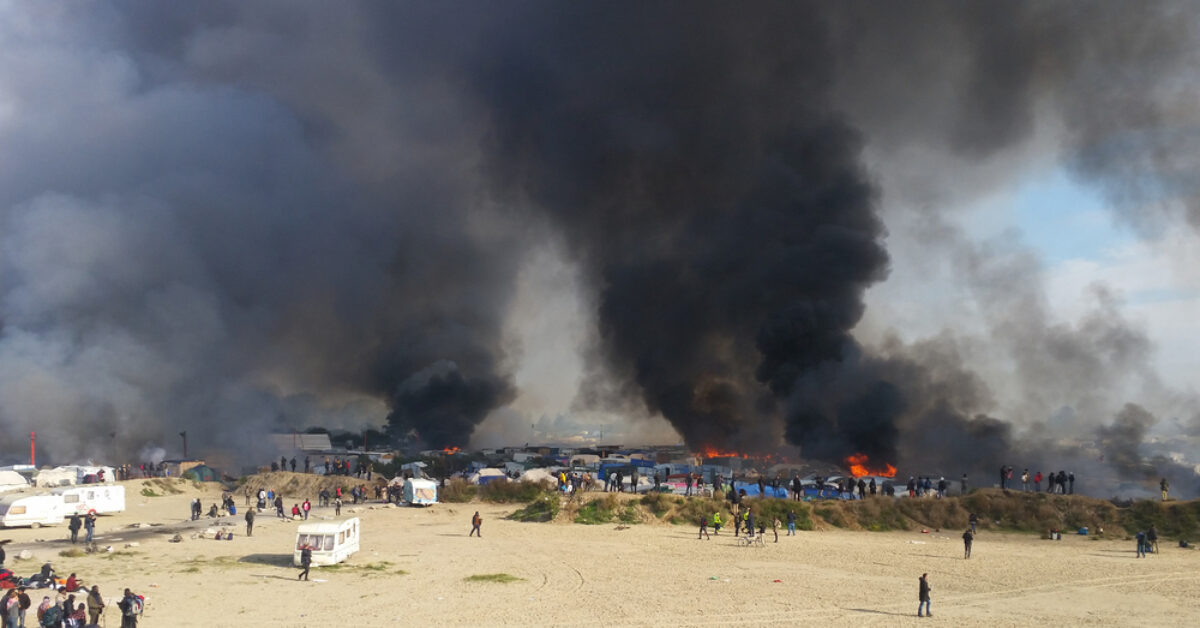 Calais - October 27, 2016: The Jungle of Calais is burning during the eviction of the illegal refugee camp in the north of French  (see bottom of article for photo credit)