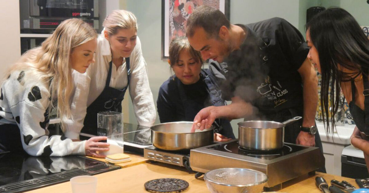 A group of people preparing food in a kitchen