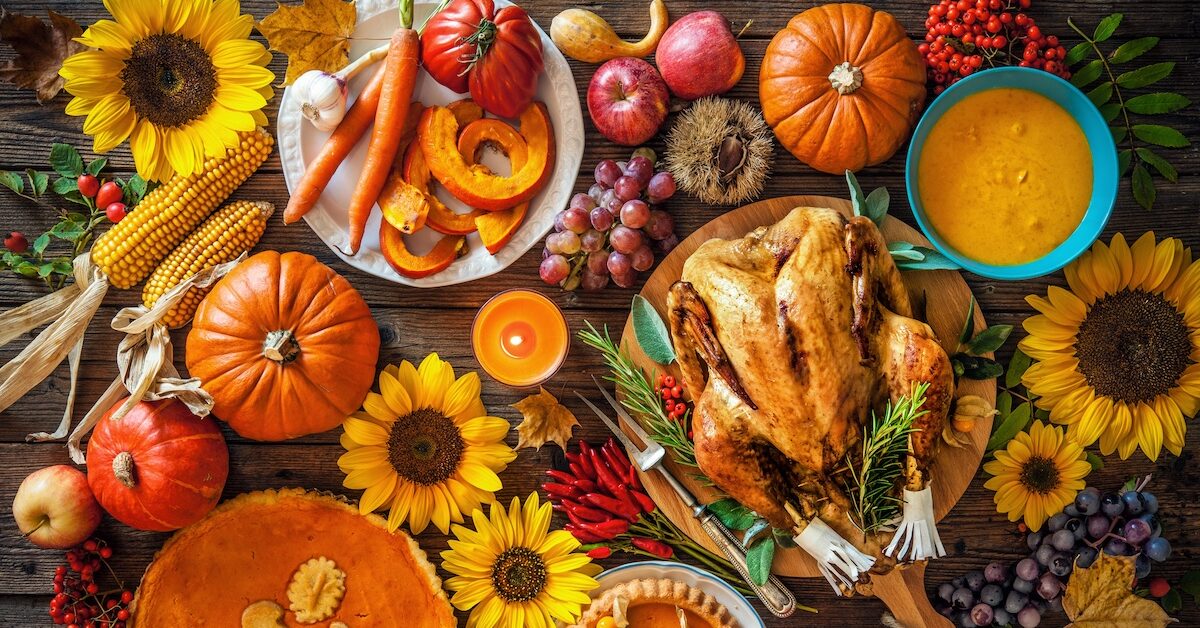 Thanksgiving dinner spread, with turkey, squash, and seasonal vegetables