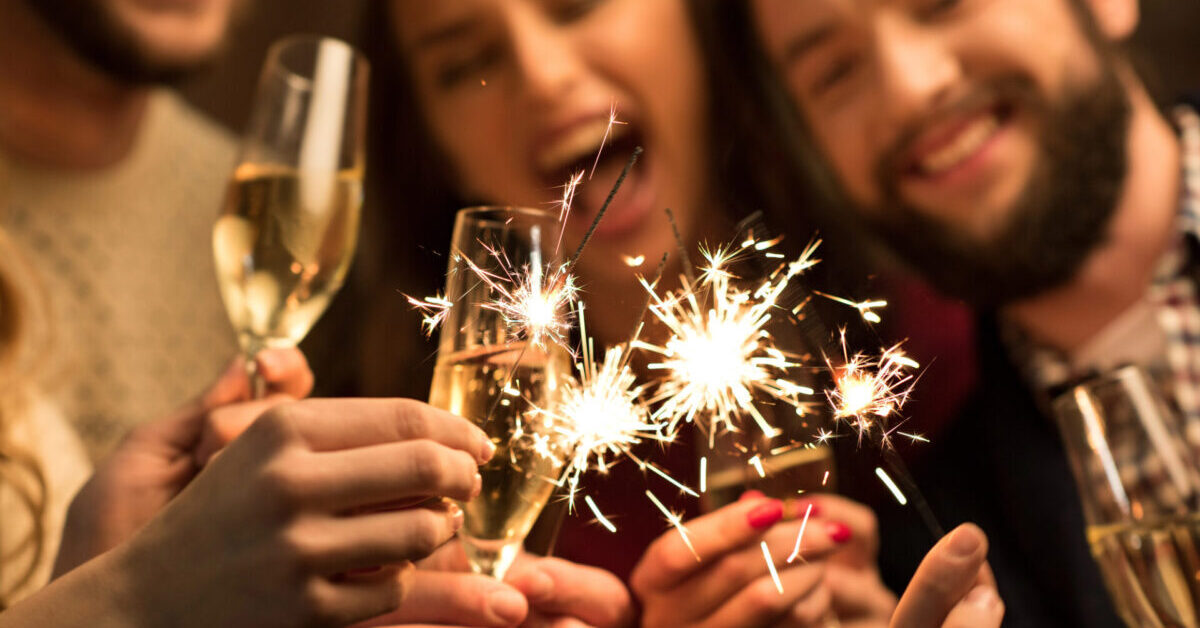 People with glasses of champagne and sparklers.