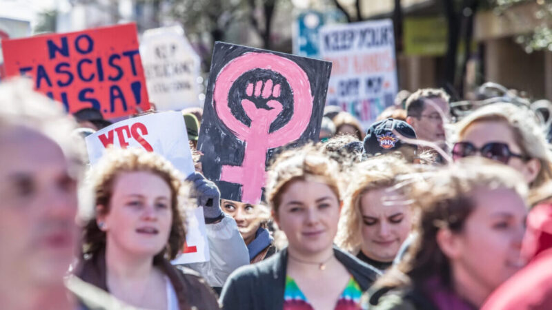 Woman Holding signs.