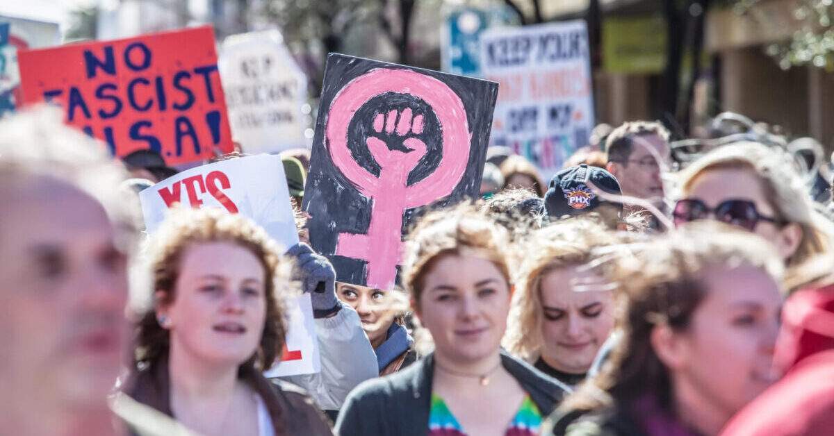 Woman Holding signs.