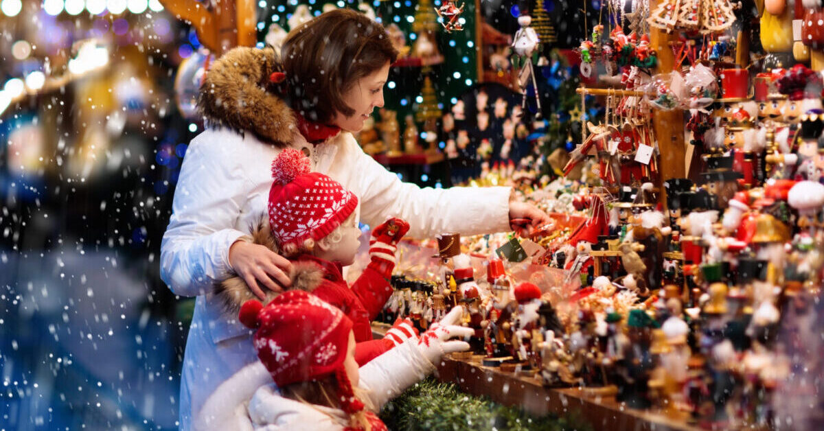Family shopping presents in Christmas market.