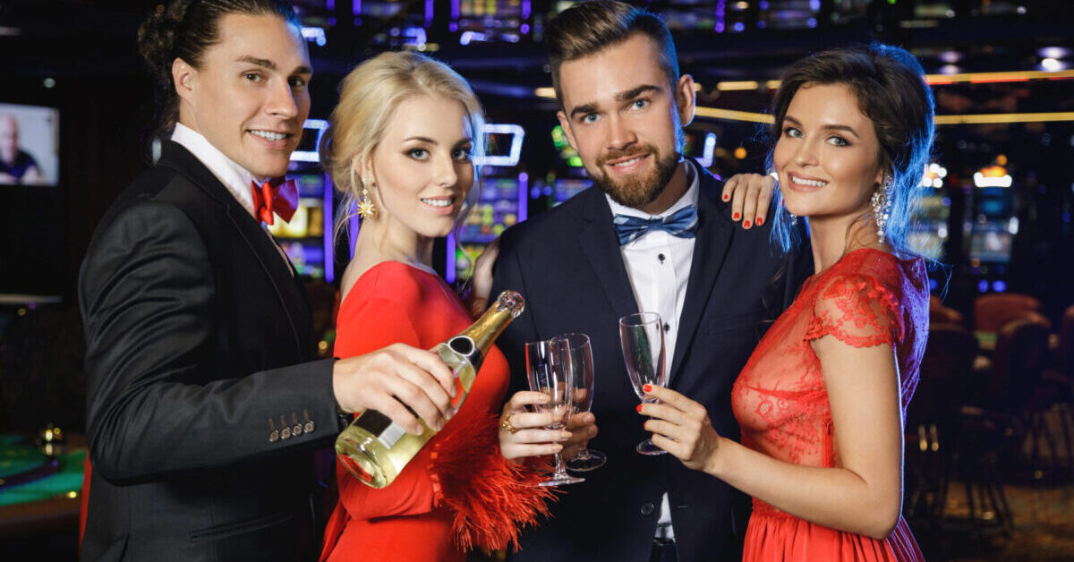 Group of happy people during celebration drinking sparkling wine.