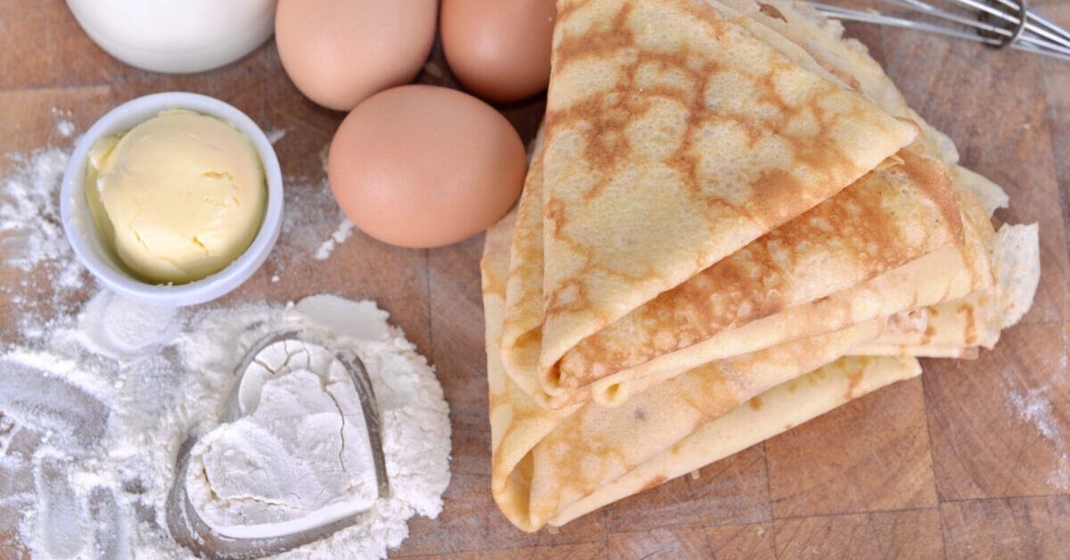 Homemade french pancakes with ingredient and heart shaped in the flour.
