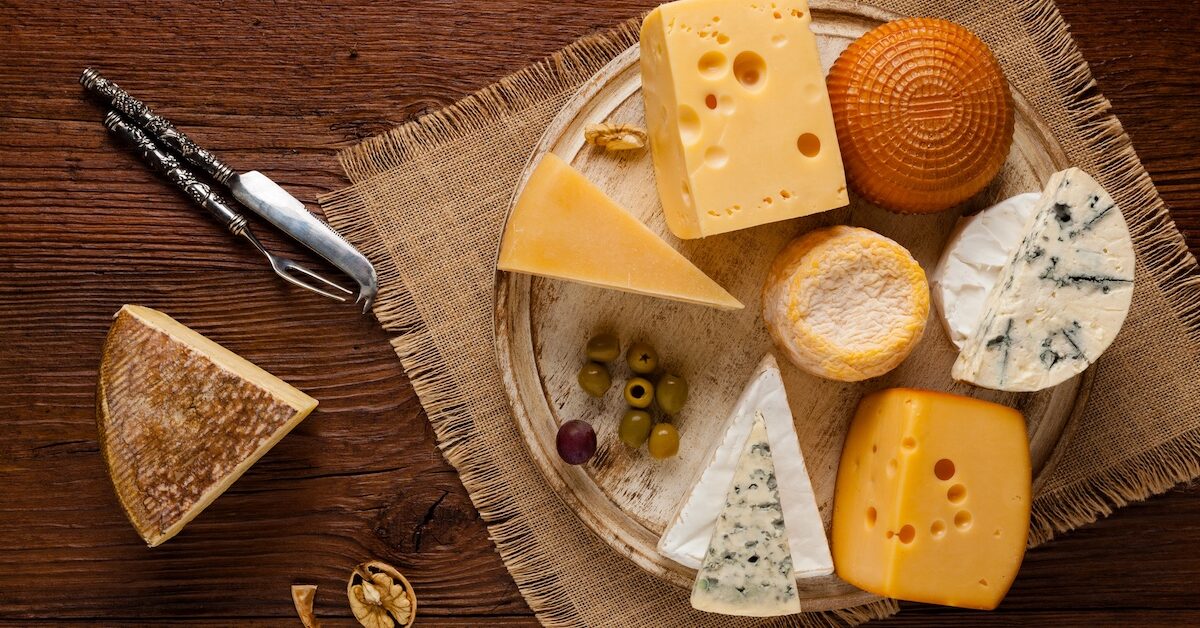 Mix cheese on wooden board.