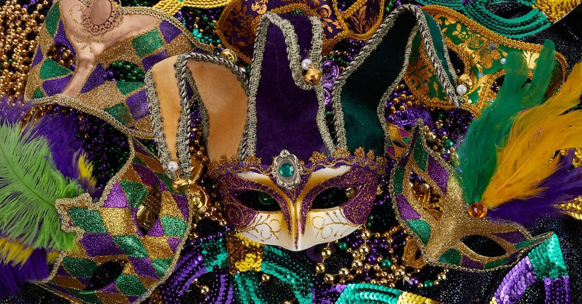 Mardi Gras Mask and colorful Mardi Gras Beads Background.