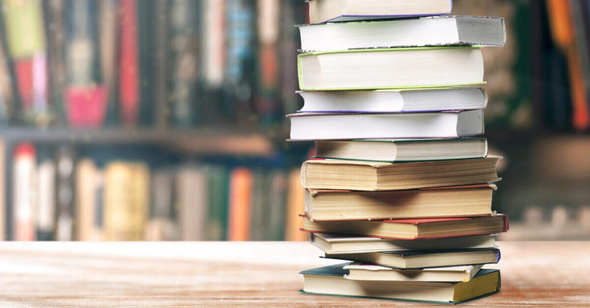 A stack of books on the shelf.