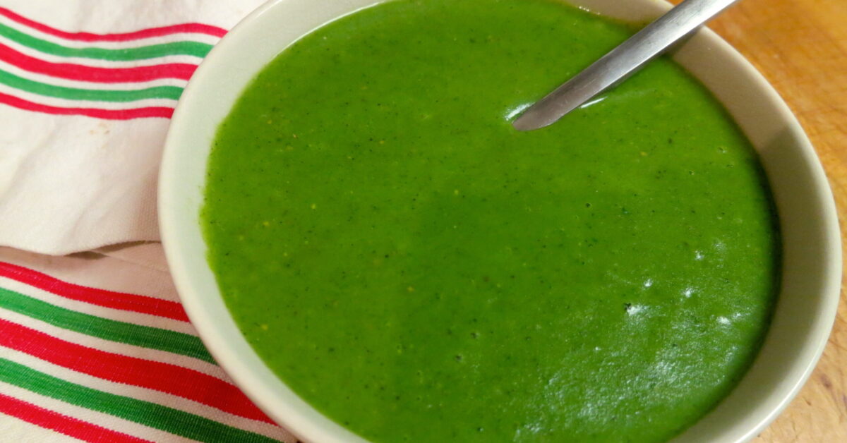 A bowl of soup on a green plate