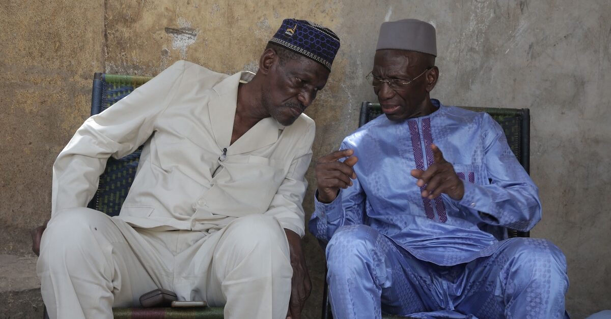 Two men in African dress having a conversation.